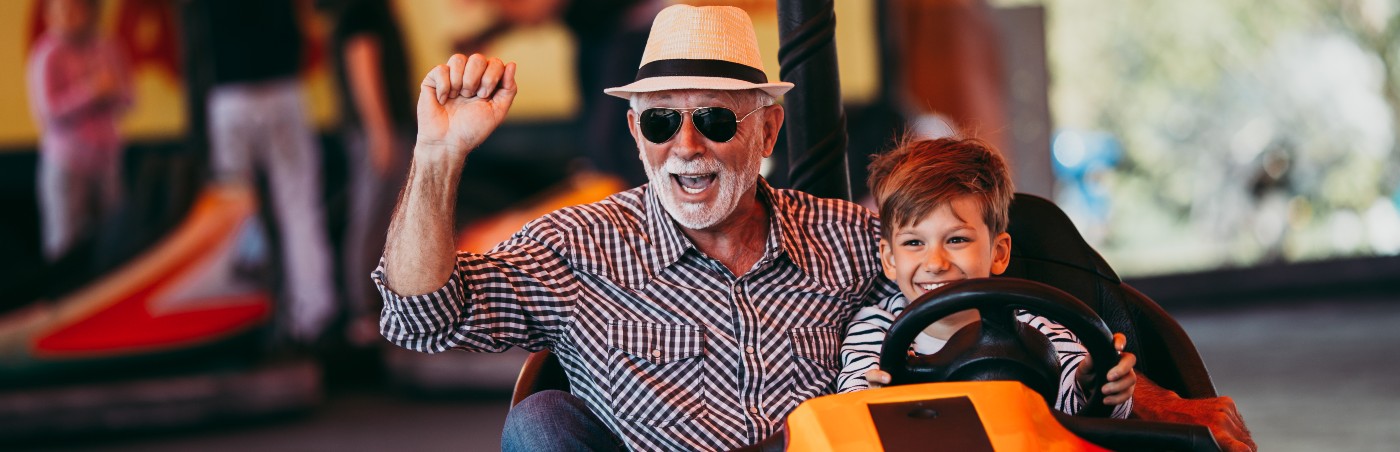 Image showing grandfather and grandson riding a fairground ride